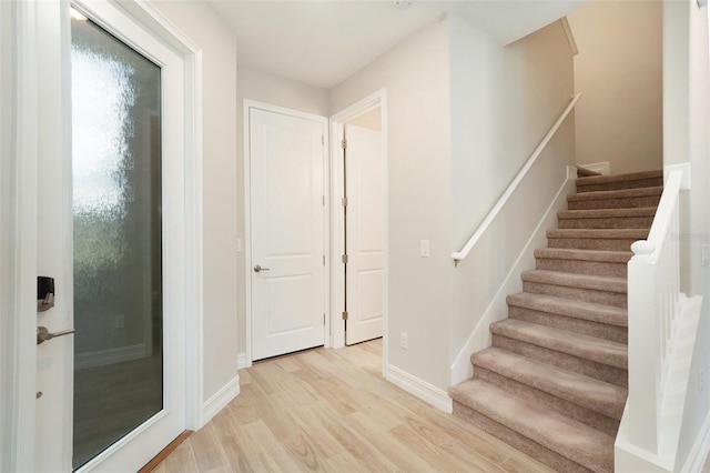 stairs with hardwood / wood-style floors