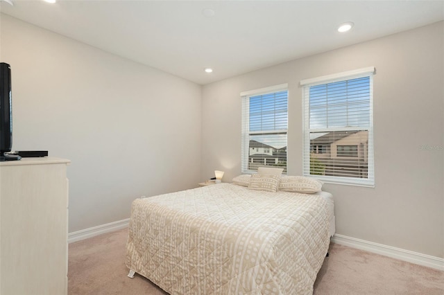 bedroom featuring light colored carpet