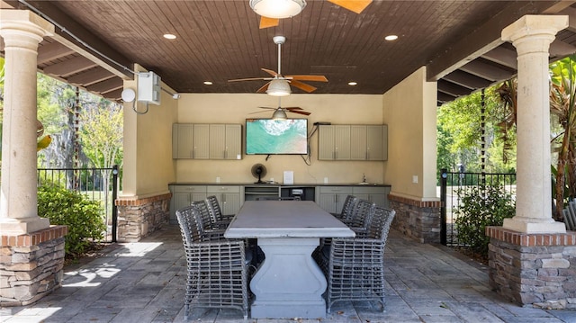 view of patio / terrace featuring exterior bar, ceiling fan, and exterior kitchen