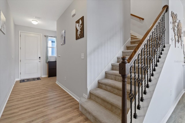 foyer entrance with light wood-type flooring