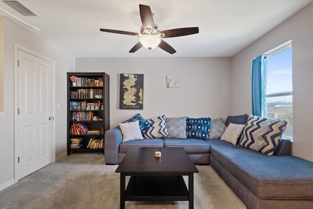 carpeted living room featuring ceiling fan