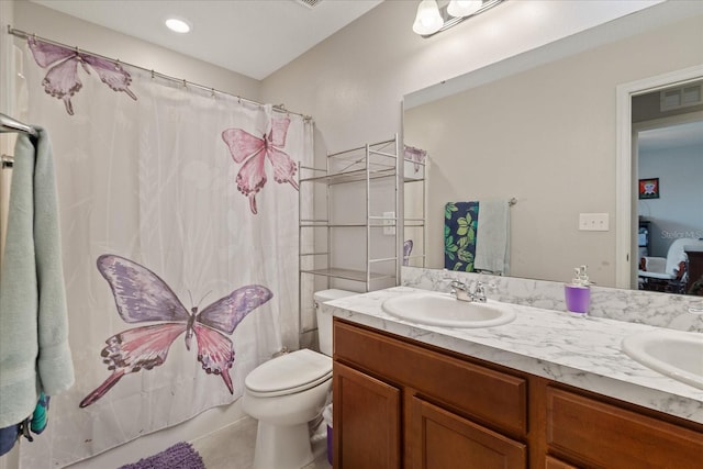 bathroom with tile patterned floors, vanity, a shower with shower curtain, and toilet