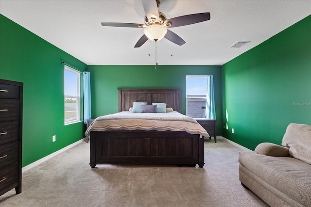 bedroom with light colored carpet and ceiling fan