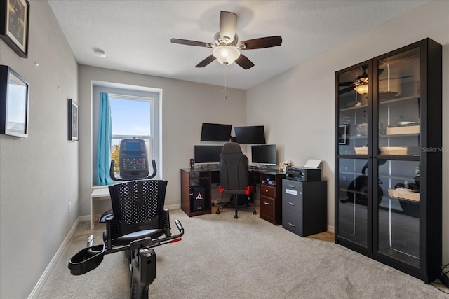 carpeted office with ceiling fan and a textured ceiling