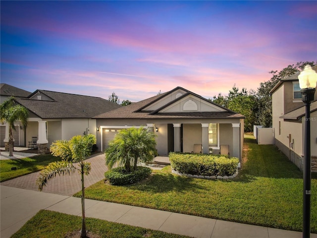 view of front of property with a lawn and a garage