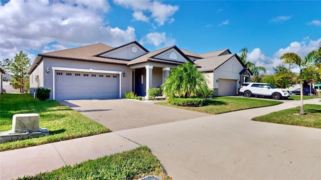 view of front facade with a front yard and a garage