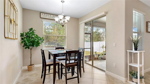 dining area with light tile patterned floors and an inviting chandelier