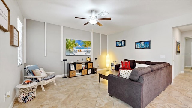 tiled living room with ceiling fan