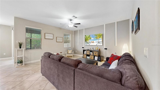 tiled living room featuring ceiling fan