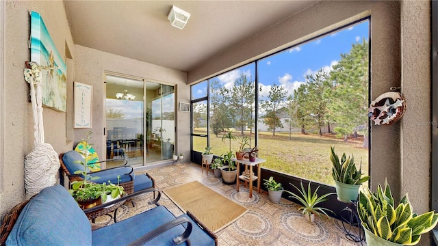 sunroom featuring an inviting chandelier