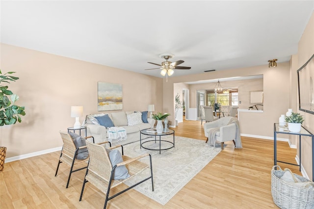 living room featuring ceiling fan and light hardwood / wood-style floors