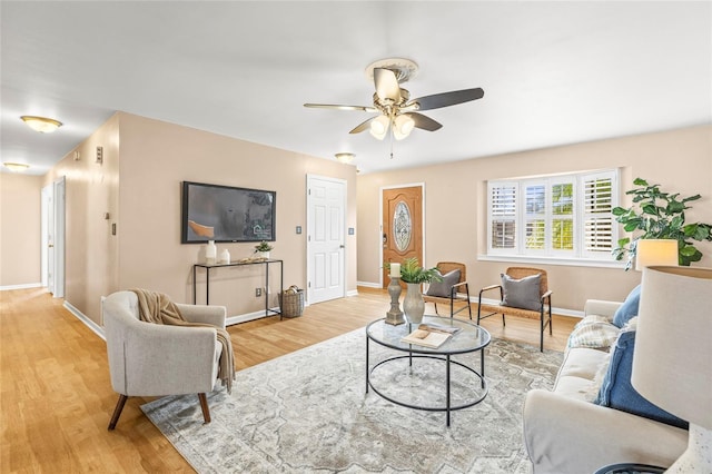 living room featuring ceiling fan and light hardwood / wood-style flooring