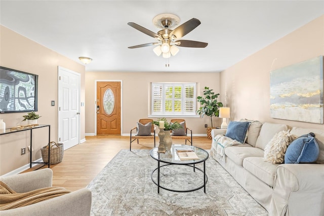 living room with ceiling fan and light hardwood / wood-style floors