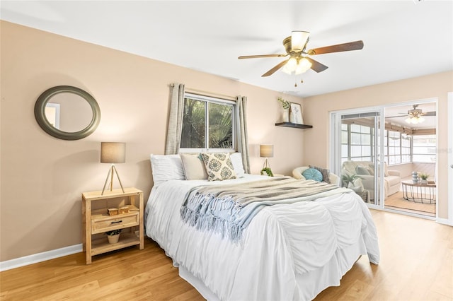 bedroom featuring access to exterior, light hardwood / wood-style flooring, and ceiling fan