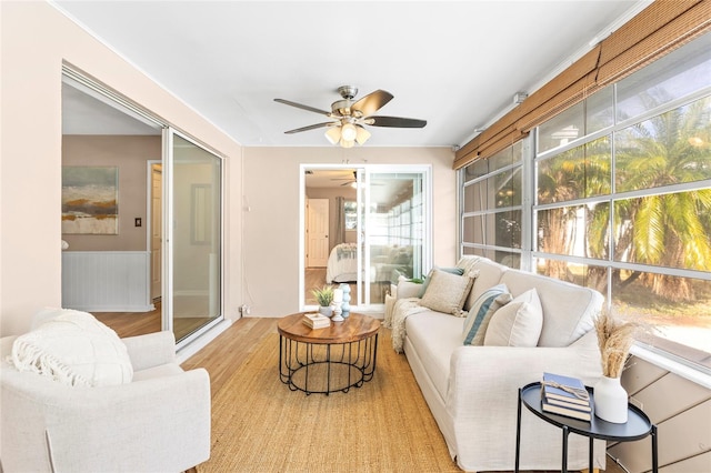 sunroom / solarium featuring ceiling fan