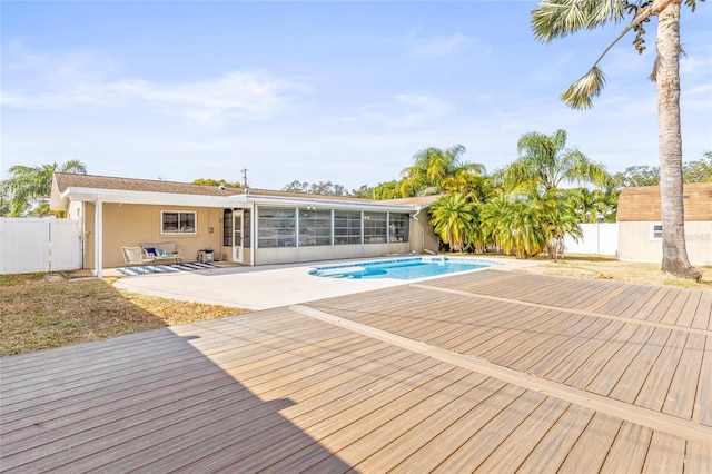 view of pool featuring a patio area and a sunroom