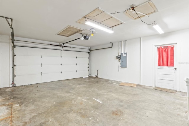 garage with electric panel and a garage door opener