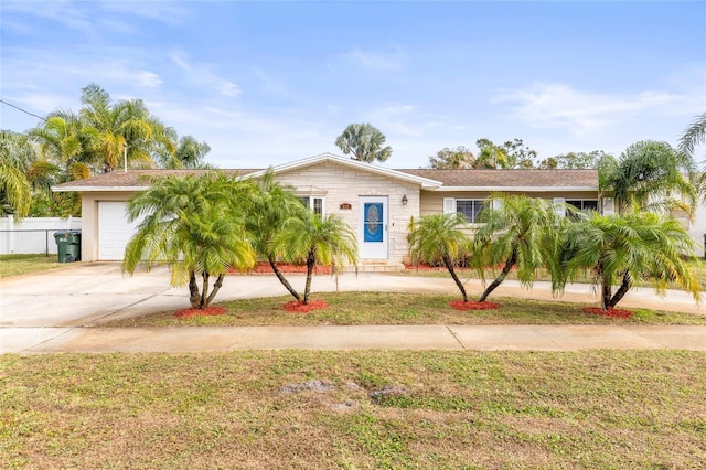 view of front of property featuring a front lawn and a garage