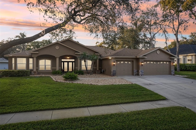 view of front of property featuring a yard and a garage