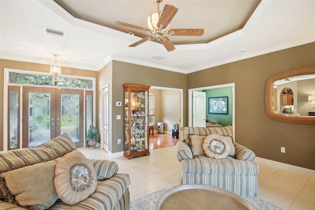 living room featuring ornamental molding, light tile patterned floors, and french doors