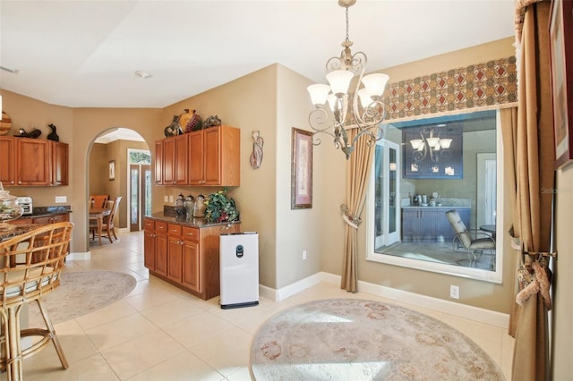 kitchen with a notable chandelier, light tile patterned floors, and hanging light fixtures