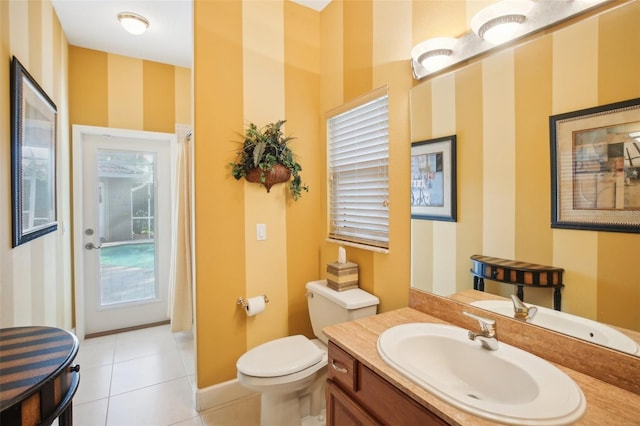 bathroom with tile patterned flooring, vanity, and toilet