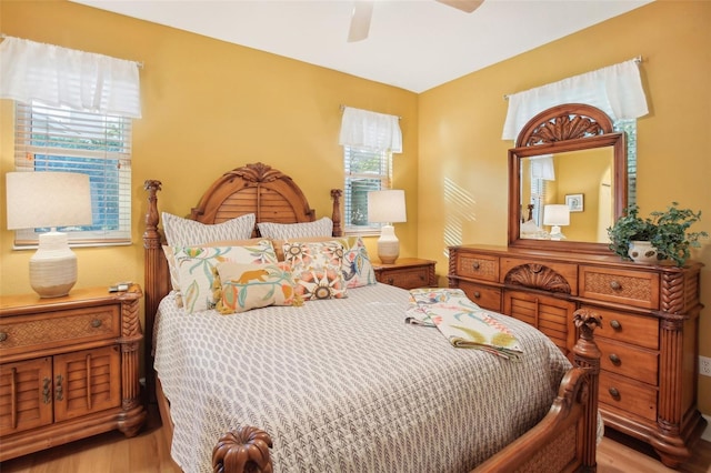 bedroom featuring multiple windows, ceiling fan, and light hardwood / wood-style floors