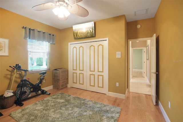 interior space with hardwood / wood-style flooring, ceiling fan, and a closet