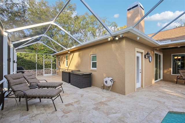 view of patio featuring glass enclosure