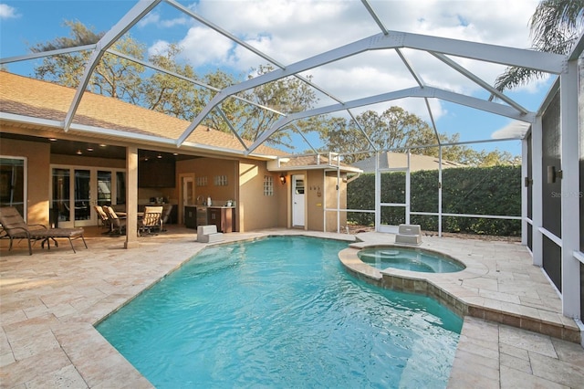 view of swimming pool featuring a lanai, a patio area, and an in ground hot tub