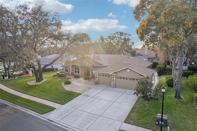 view of front of home featuring a front yard and a garage