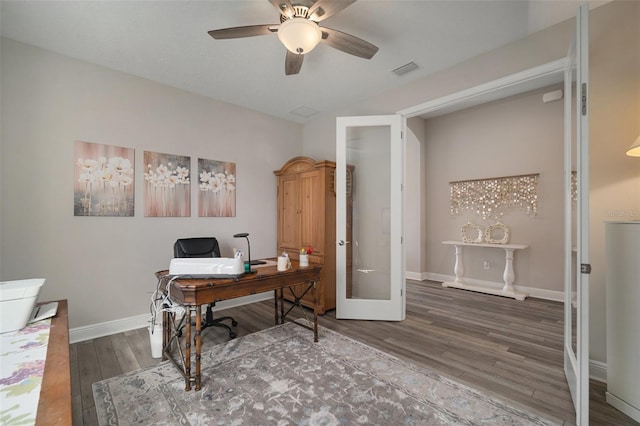 home office featuring french doors, visible vents, a ceiling fan, wood finished floors, and baseboards