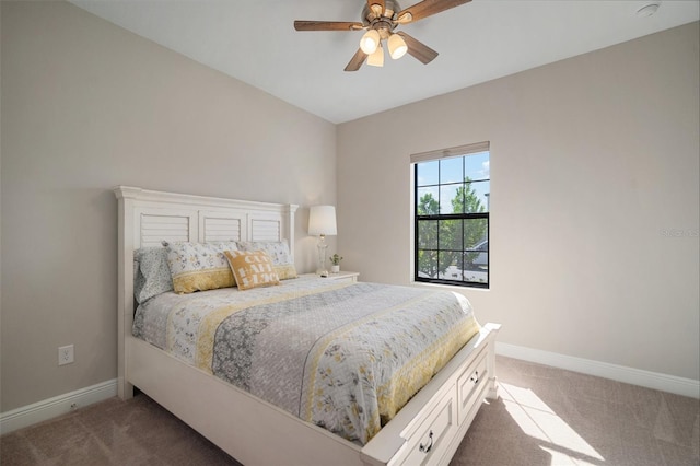 carpeted bedroom with ceiling fan and baseboards