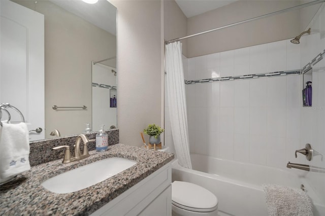 bathroom with vanity, toilet, and shower / bath combo with shower curtain