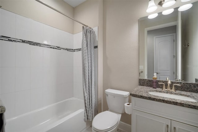 bathroom featuring shower / tub combo, a textured wall, vanity, and toilet