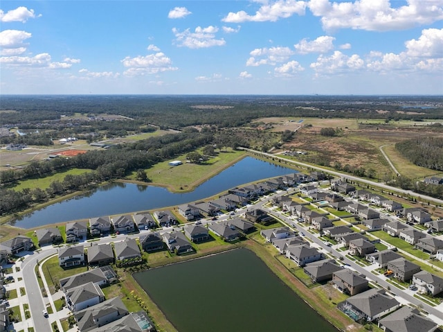 drone / aerial view with a water view and a residential view