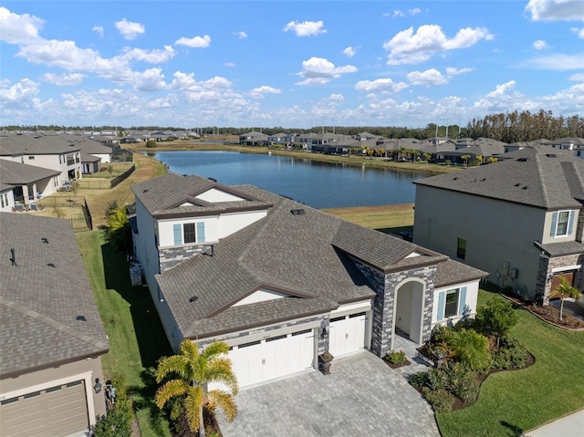 birds eye view of property with a residential view and a water view