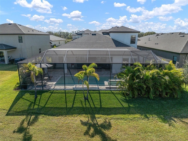 view of yard featuring glass enclosure, a patio area, a residential view, and an outdoor pool