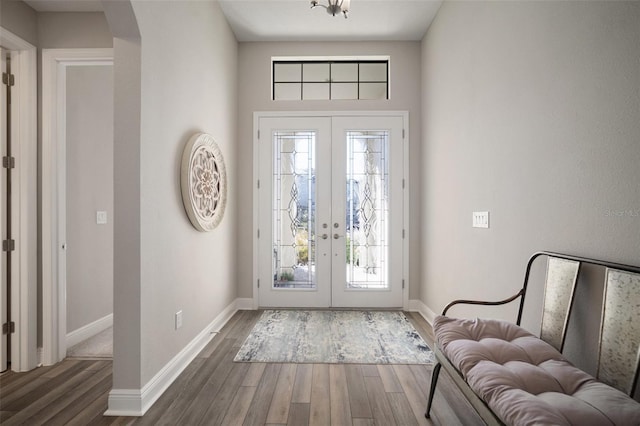 entrance foyer with french doors, plenty of natural light, dark wood finished floors, and baseboards