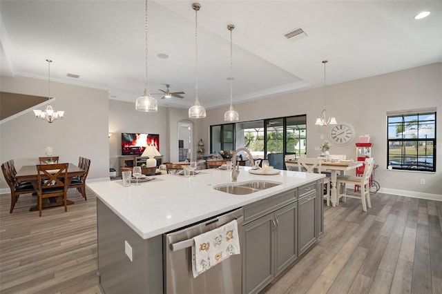 kitchen featuring a sink, a center island with sink, visible vents, and stainless steel dishwasher