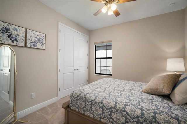 carpeted bedroom with a ceiling fan and baseboards