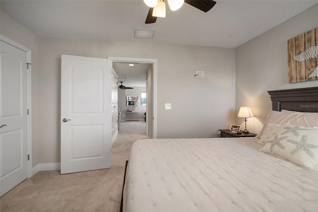 bedroom with baseboards, visible vents, a ceiling fan, and light colored carpet