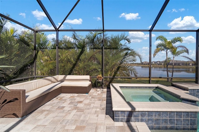 view of pool with a patio, a water view, outdoor lounge area, glass enclosure, and an in ground hot tub