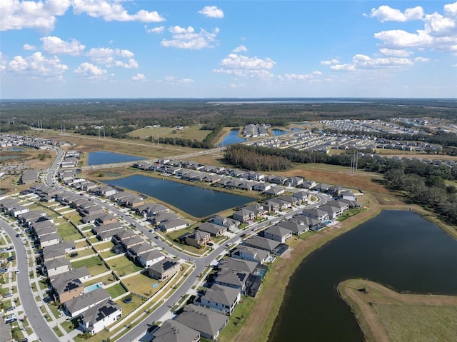 drone / aerial view with a water view and a residential view