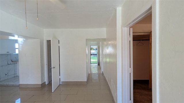 hall featuring light tile patterned floors