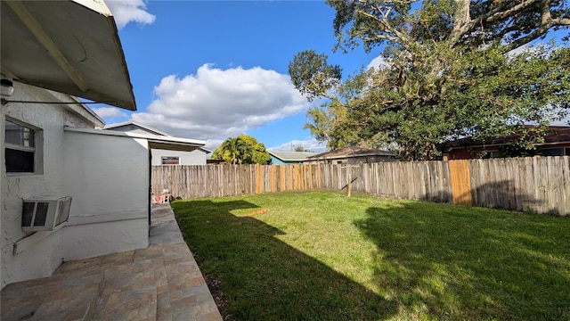 view of yard with a wall unit AC