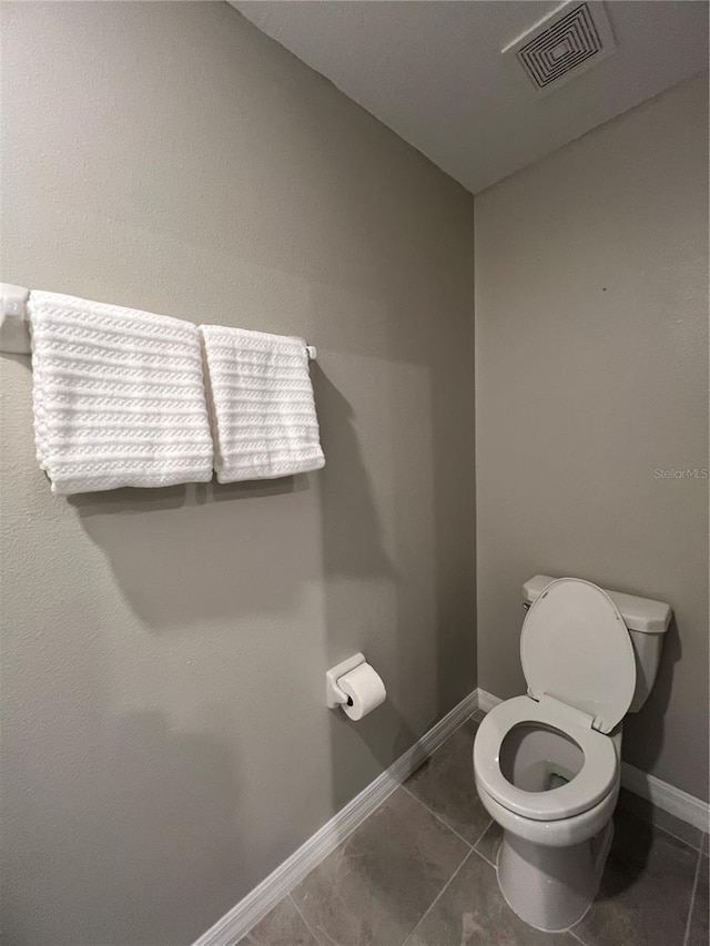 bathroom featuring toilet and tile patterned floors