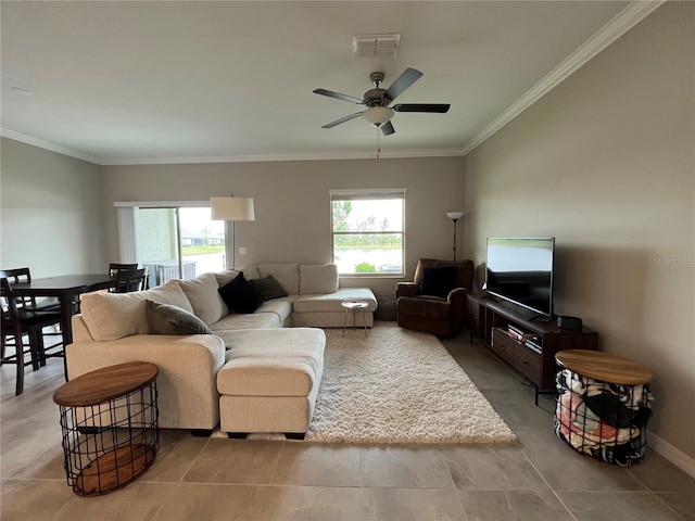 living room featuring ornamental molding, ceiling fan, and a healthy amount of sunlight