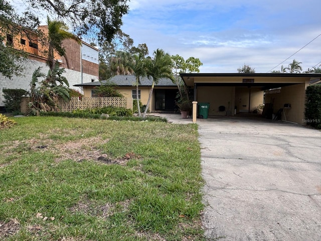 ranch-style home with a front lawn and a carport