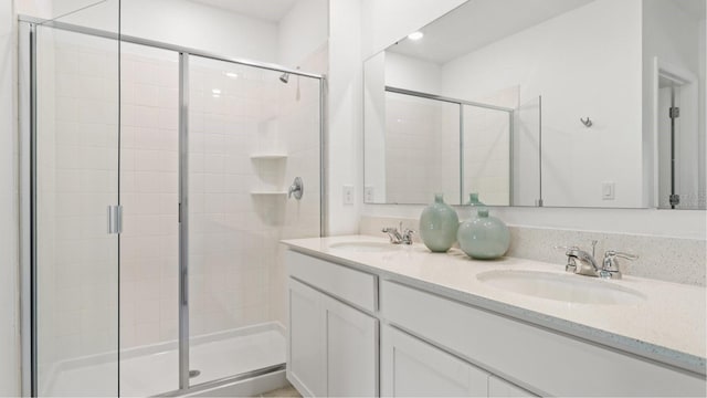 bathroom featuring vanity and an enclosed shower